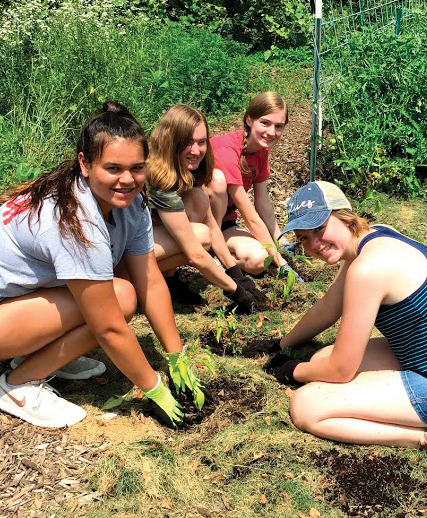 Young students working in community garden