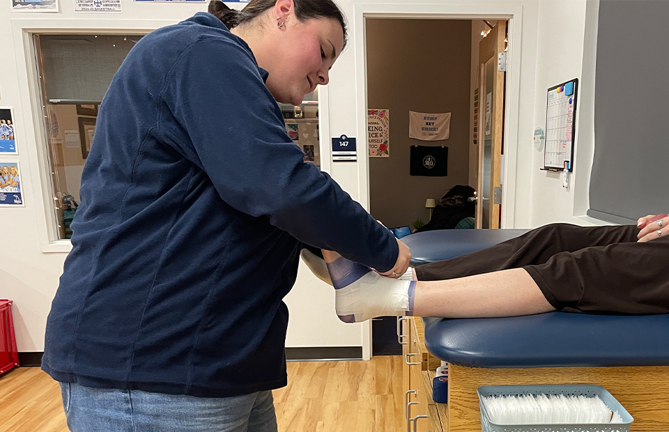 Student Wrapping Ankle