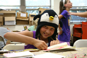 Jenna Long, 11, of North Liberty, Indiana, works on a project during Fine Arts Camp. Her penguin's name is Jeffri.