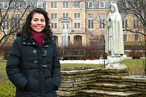 Silvia, a business administration major, visits one of the college's most beloved spots: a statue of Saint Mary on an island in Lake Marian.